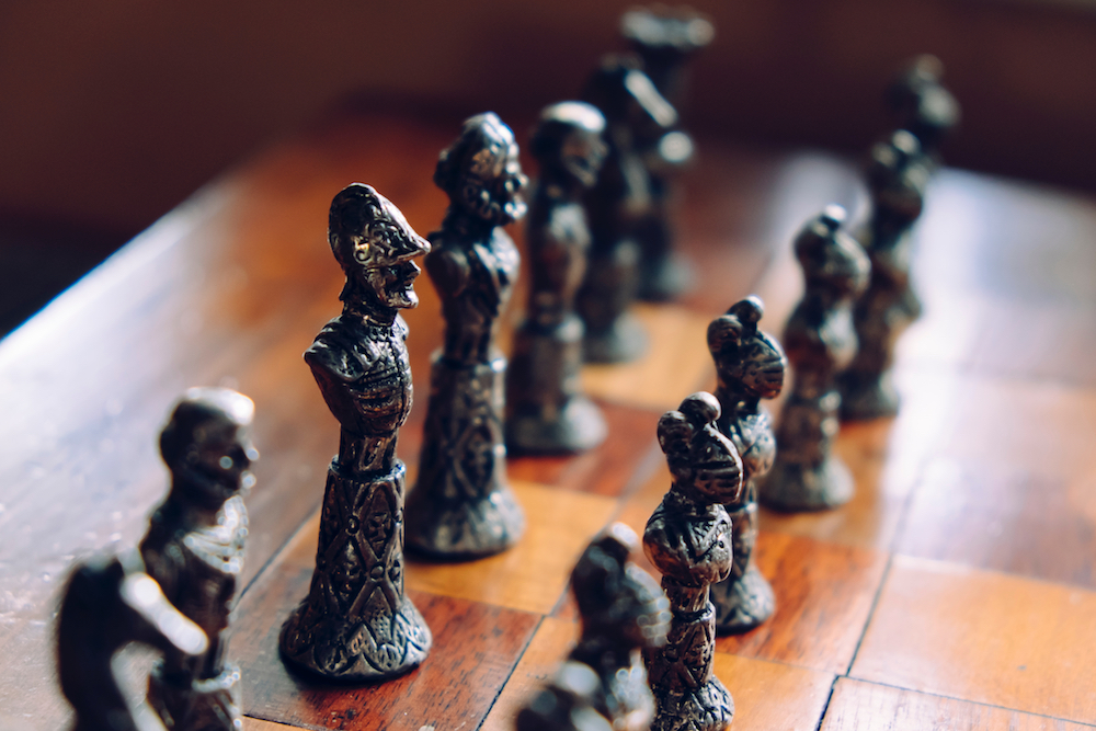Partial view of an old Chess board with Pewter chess pieces.